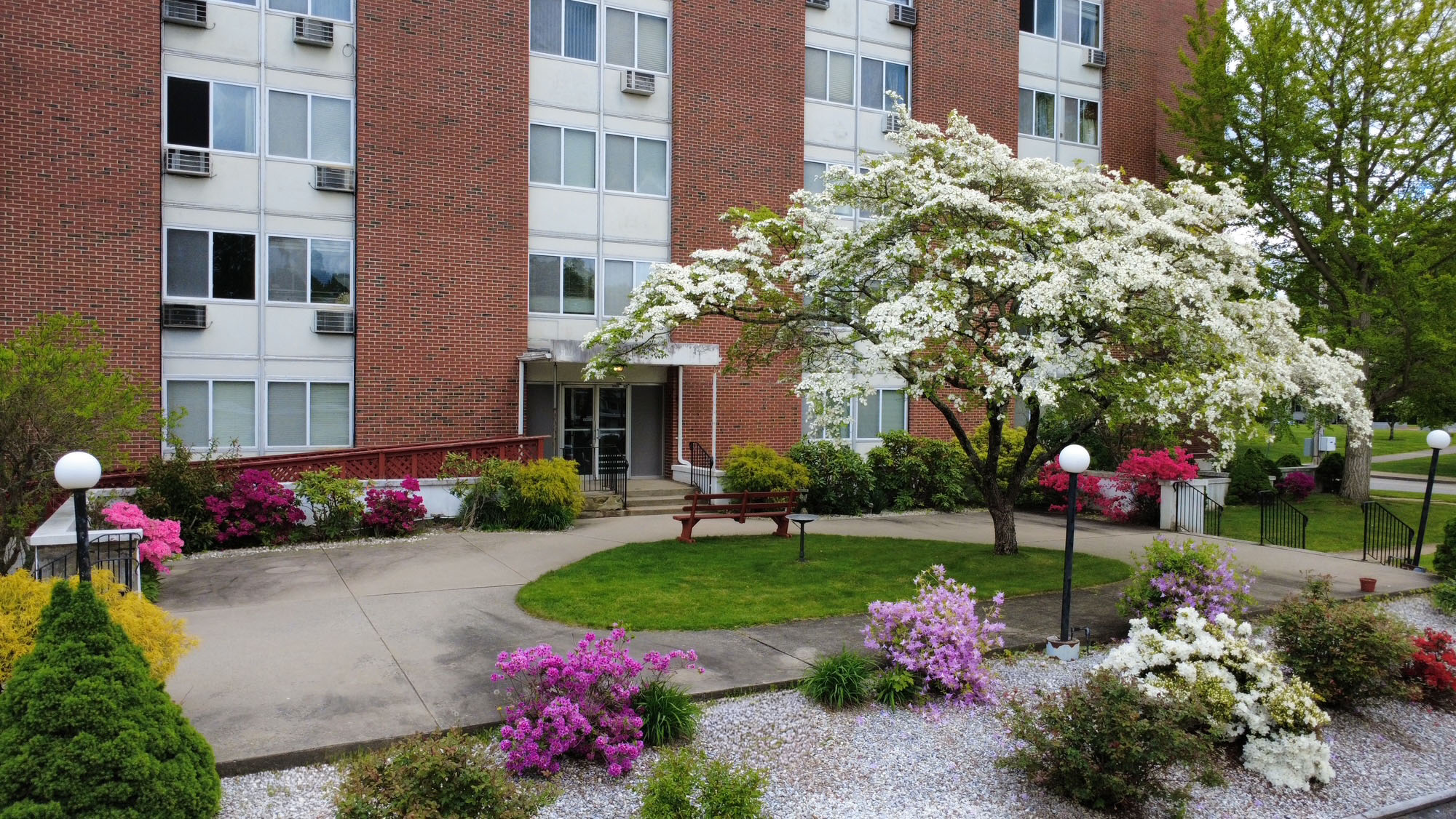 Blackstone Apartments entrance with flowering trees and landscaped walkways